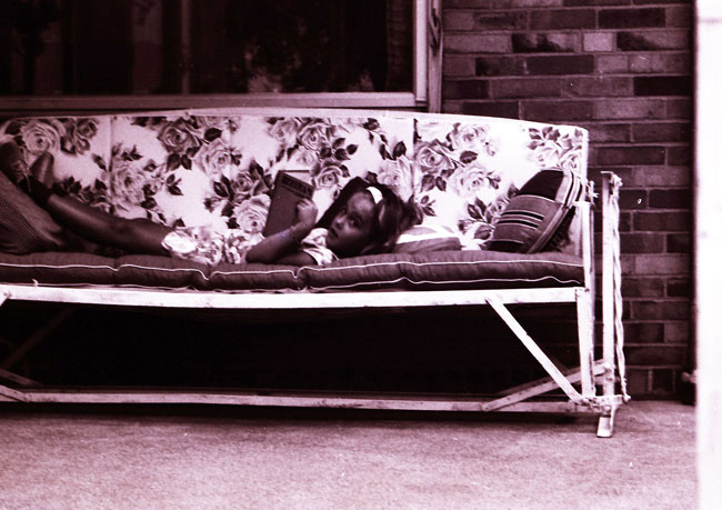 Me age 9 (I think) reading on Grandma's glider