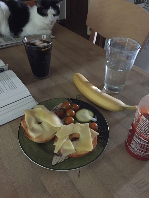 Jarlsberg on an egg bagel with Siracha, and zucchini pickles. Banana on the side.